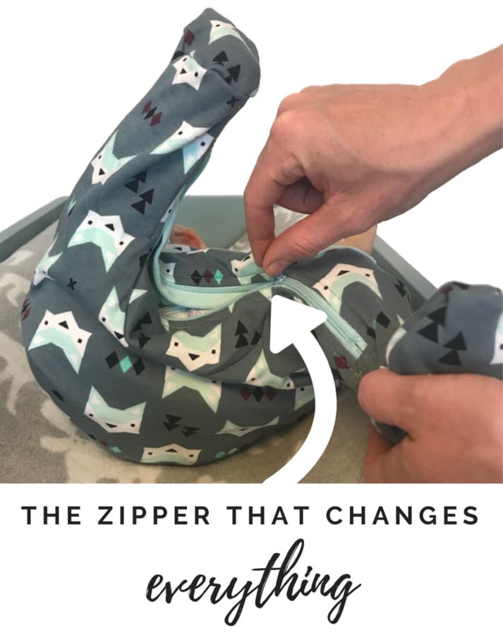 
                  
                    close up photo of inseam diaper changing zipper in action with large arrow pointing to zipper
                  
                