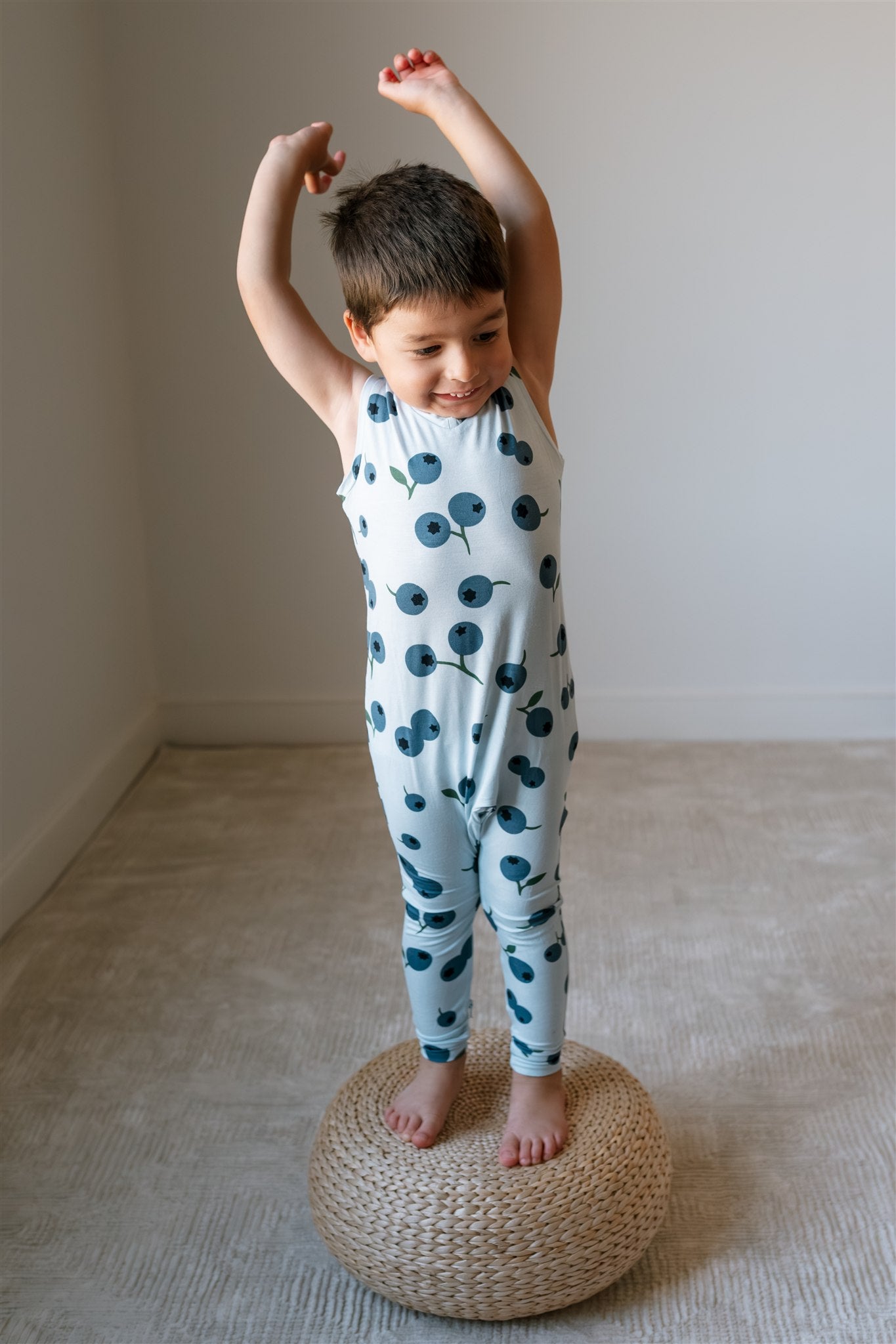 toddler wearing blu Zippyjamz romper with blueberry print