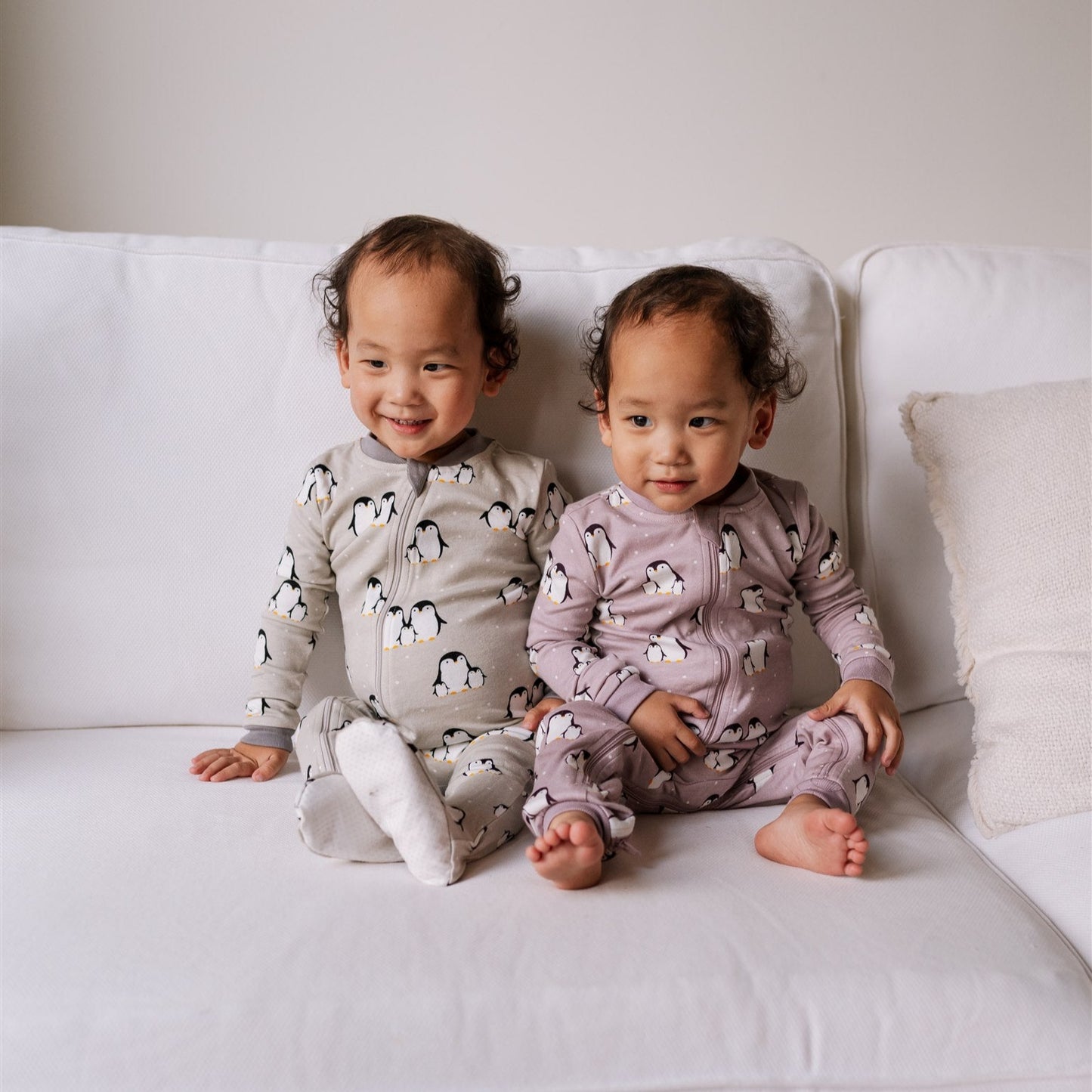 two babies in ZippyJamz sleepers with penguins