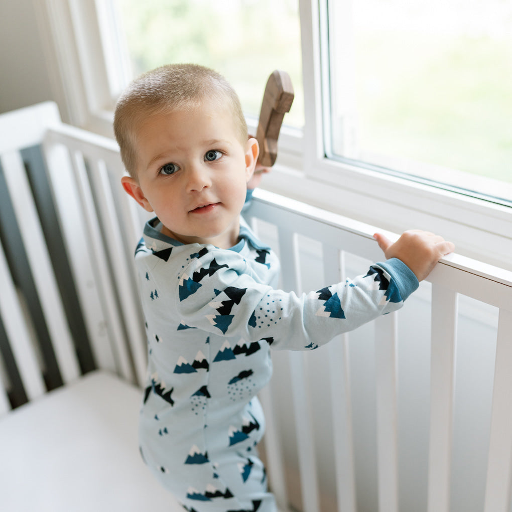 Child in ZippyJamz sleeper with blue Little Adventurer parttern