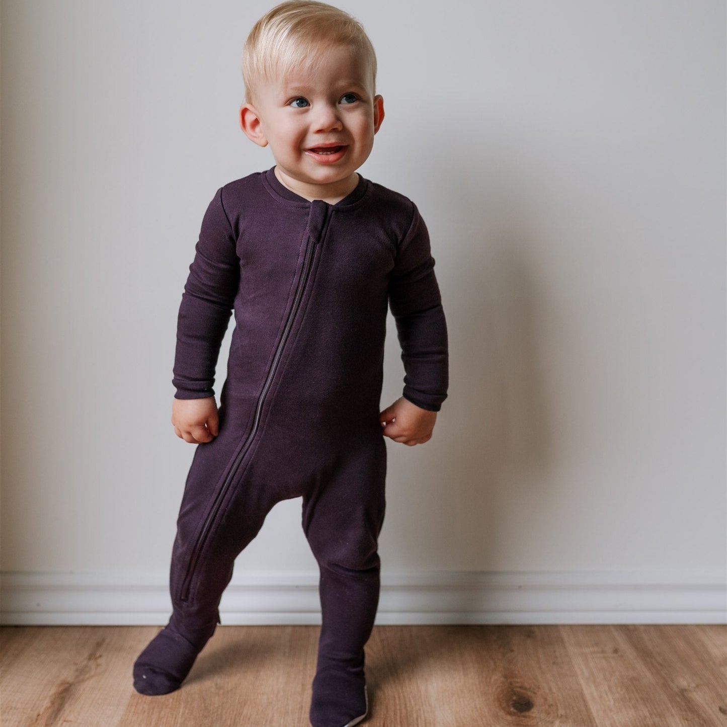 blonde child standing wearing ZippyJamz Midnight Dreams footed sleeper