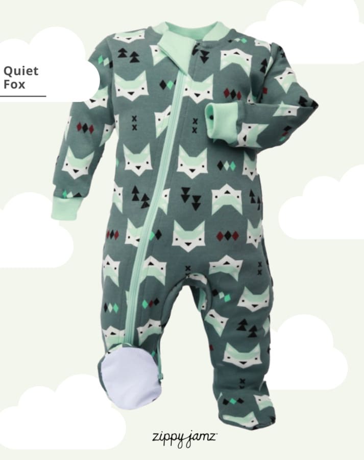 
                  
                    green cotton baby sleeper with fox head and pine tree imagery on a light blue background with clouds
                  
                